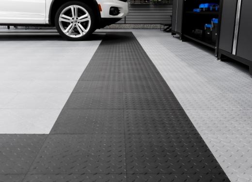 A white car parked on polypropylene garage flooring in a spacious garage.